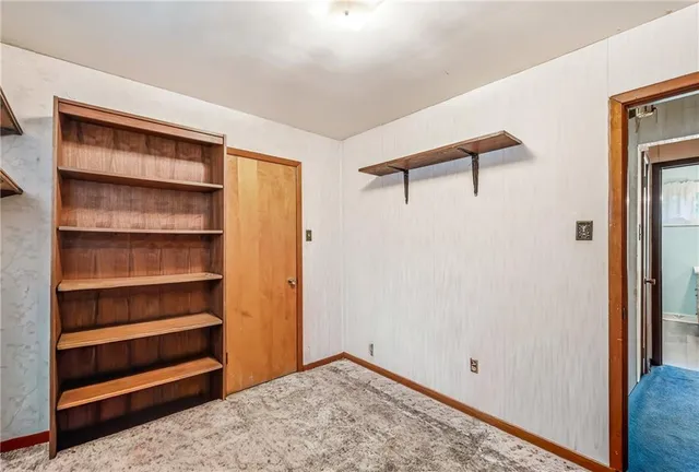 a view of walk in closet with empty racks