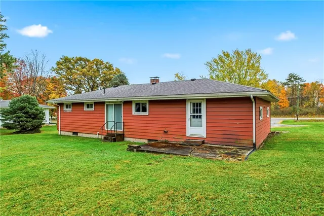 an aerial view of residential houses with outdoor space and trees