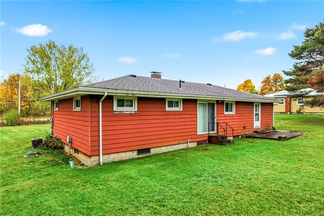 a view of a grassy field with trees