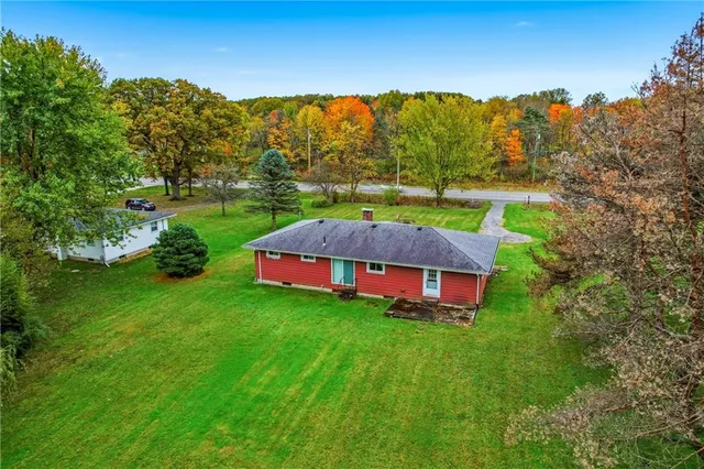 a backyard of a house with table and chairs