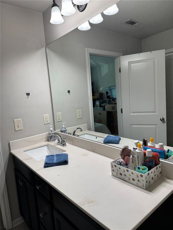 1311 Brookmere Way Cumming, GA 30040 - Photo 14 of 24 a bathroom with a sink vanity and a mirror