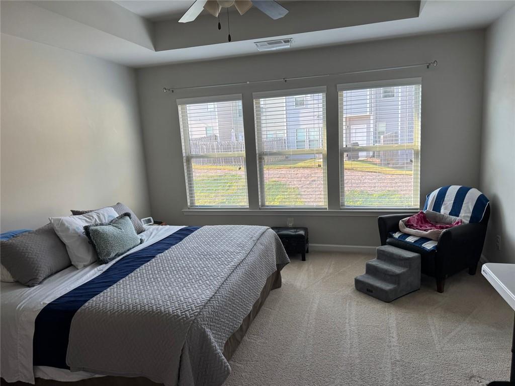 1311 Brookmere Way Cumming, GA 30040 - Photo 19 of 24 a bedroom with a bed and a couch