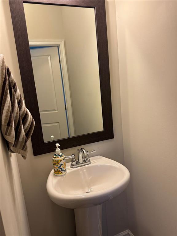 1311 Brookmere Way Cumming, GA 30040 - Photo 20 of 24 a bathroom with a sink and a mirror