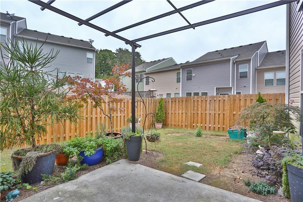 1311 Brookmere Way Cumming, GA 30040 - Photo 3 of 24 a front view of a house with garden