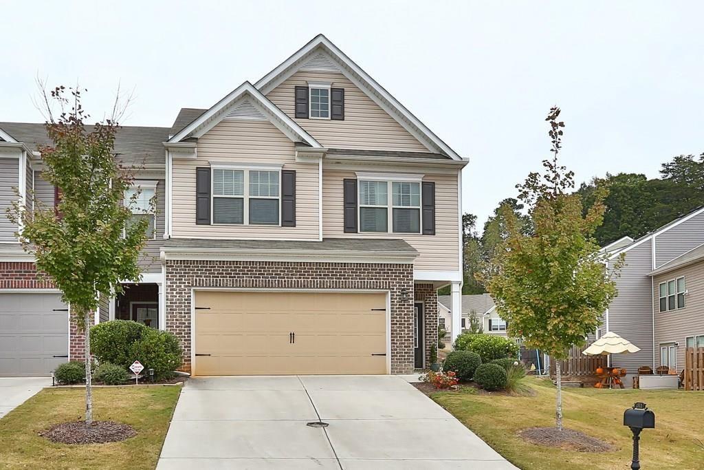1311 Brookmere Way Cumming, GA 30040 - Photo 5 of 24 a front view of a house with a garden