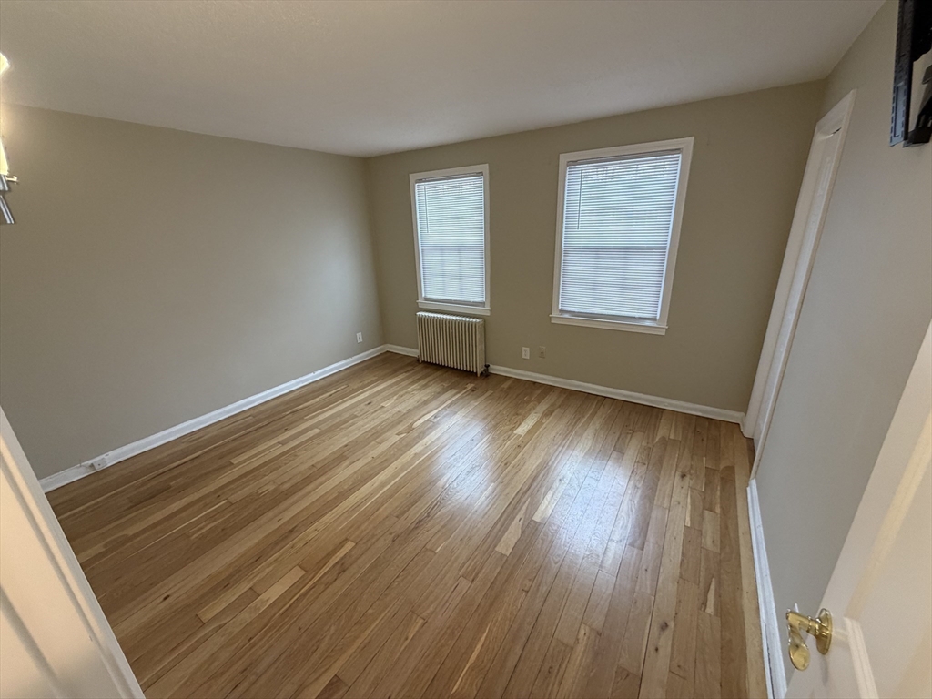 474 Cold Spring Avenue, Unit 474 West Springfield, MA 01089 - Photo 13 of 22 a view of an empty room with wooden floor and a window
