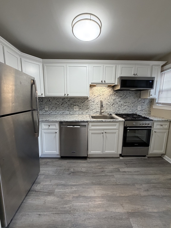 474 Cold Spring Avenue, Unit 474 West Springfield, MA 01089 - Photo 3 of 22 a kitchen with stainless steel appliances granite countertop a stove a sink and a refrigerator