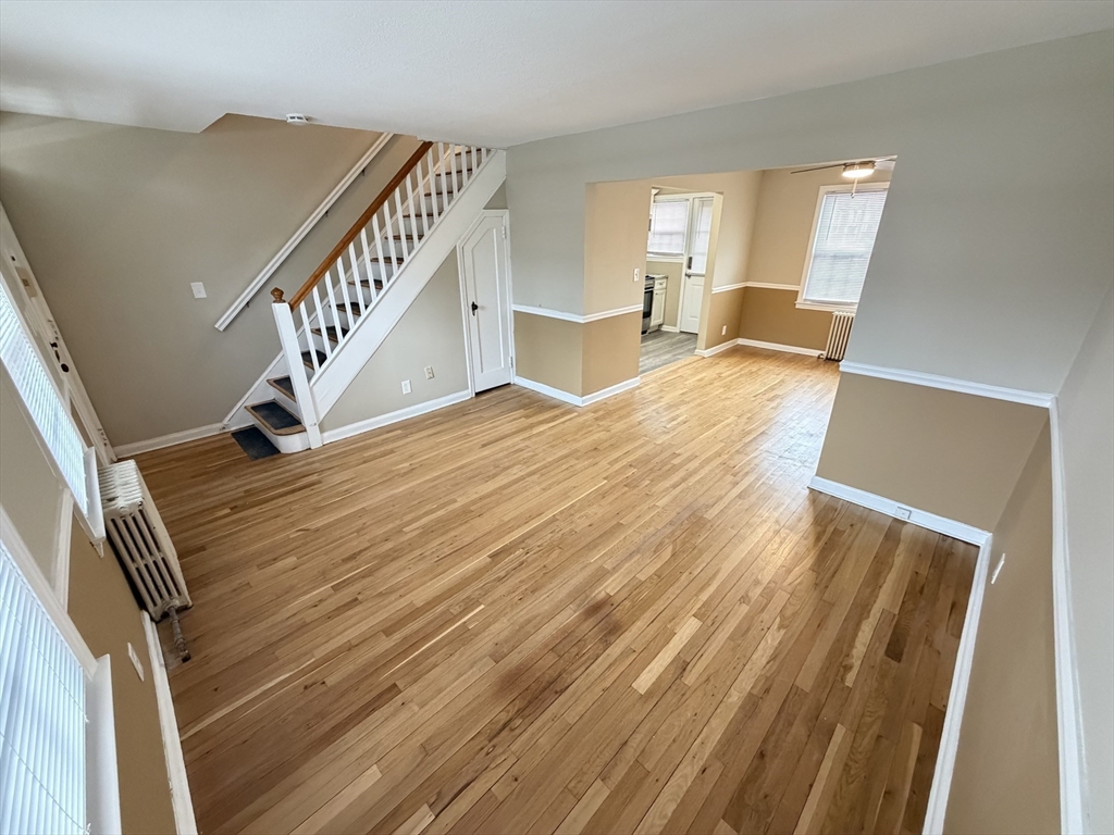 474 Cold Spring Avenue, Unit 474 West Springfield, MA 01089 - Photo 9 of 22 a view of a livingroom with wooden floor and stairs