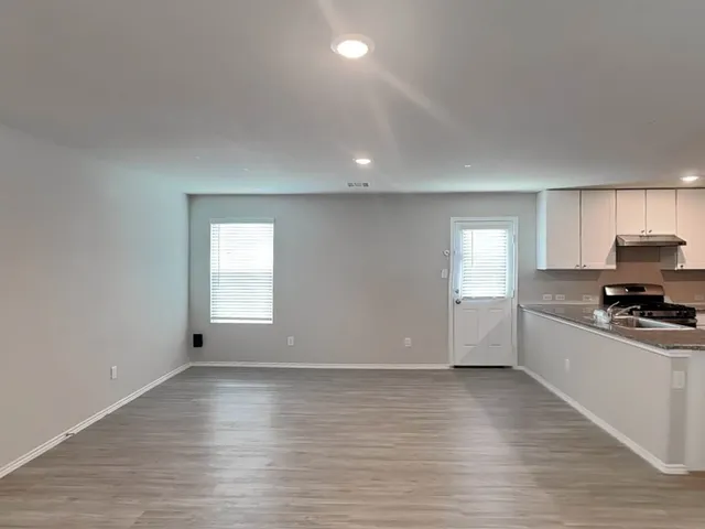 a view of a kitchen with a sink and a stove top oven