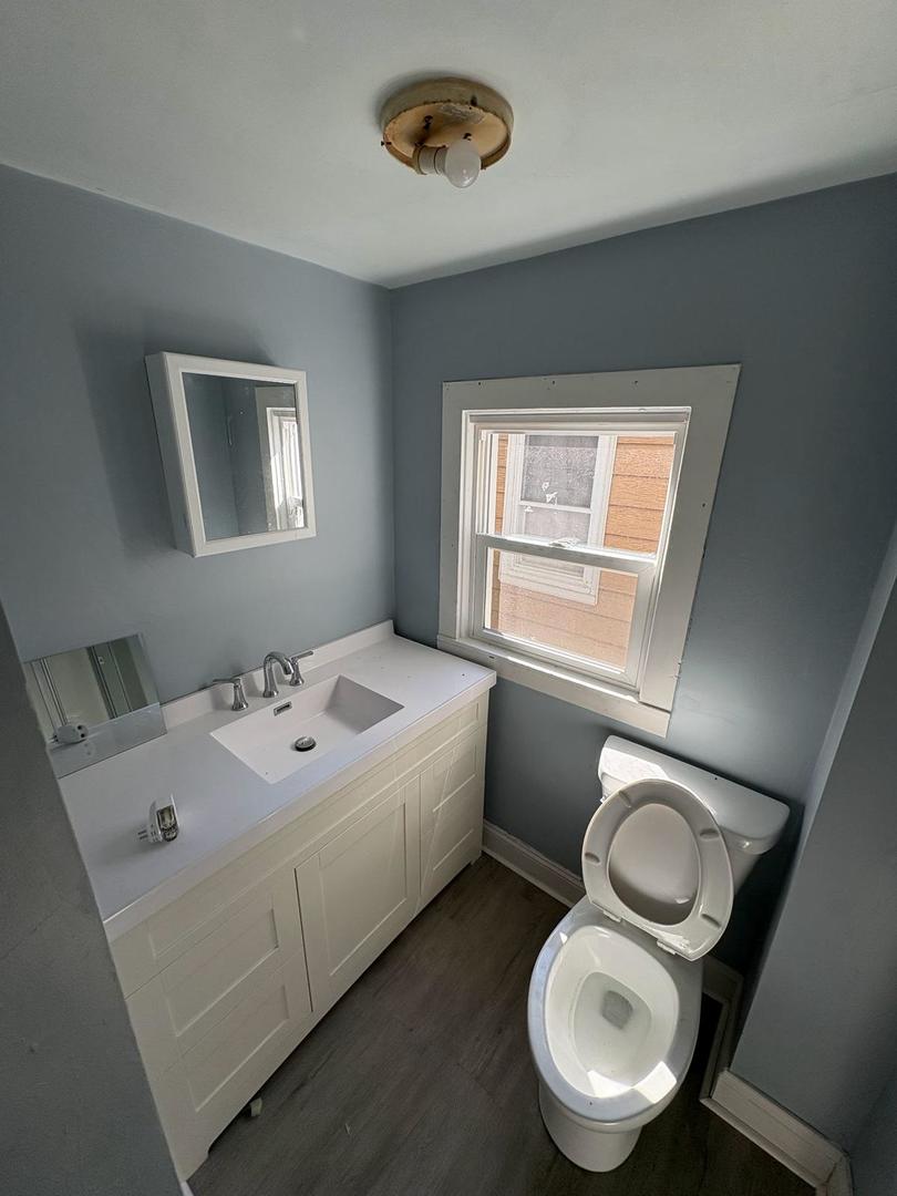 1512 West Millman Street Peoria, IL 61605 - Photo 2 of 9 a en suite bathroom with toilet sink and mirror