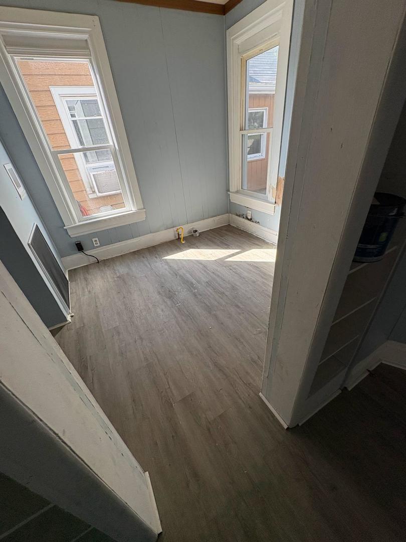 1512 West Millman Street Peoria, IL 61605 - Photo 9 of 9 a view of a livingroom with wooden floor and a window