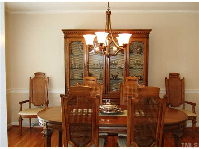 4225 Redington Drive Raleigh, NC 27609 - Photo 8 of 25 A new light fixture graces the formal dining room. Check out the Plantation shutters in the living room and the dining room. Dining Room