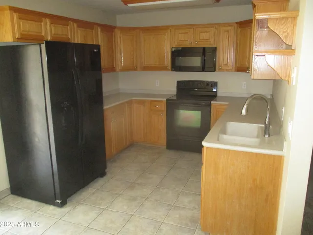 a kitchen with a refrigerator and a sink