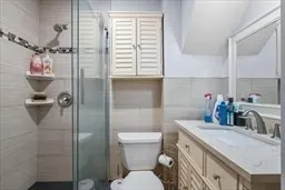 a bathroom with a granite countertop shower a sink and a toilet