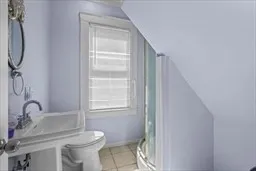 a bathroom with a toilet sink and a window