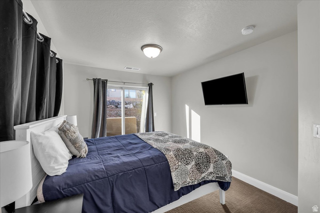 4796 Winged Foot Drive St. George, UT 84770 - Photo 25 of 33 Carpeted bedroom featuring a textured ceiling