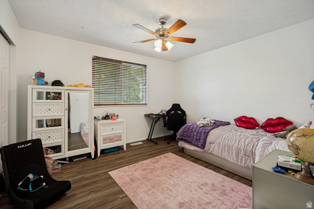 6709 Acoma Road, Unit 239 Midvale, UT 84047 - Photo 11 of 38 6711 - Main level bedroom 2. Wood-finish flooring, ceiling fan with integrated lighting, white walls, and window with blinds