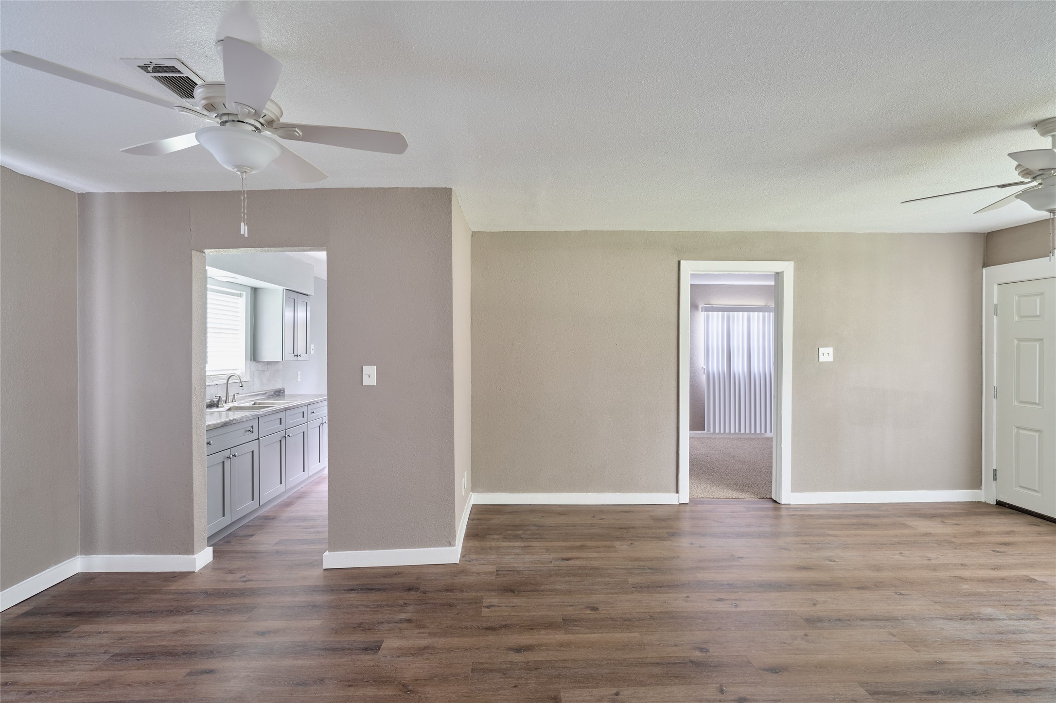4914 Yellowstone Boulevard Houston, TX 77021 - Photo 6 of 22 a view of livingroom with hardwood floor and kitchen view