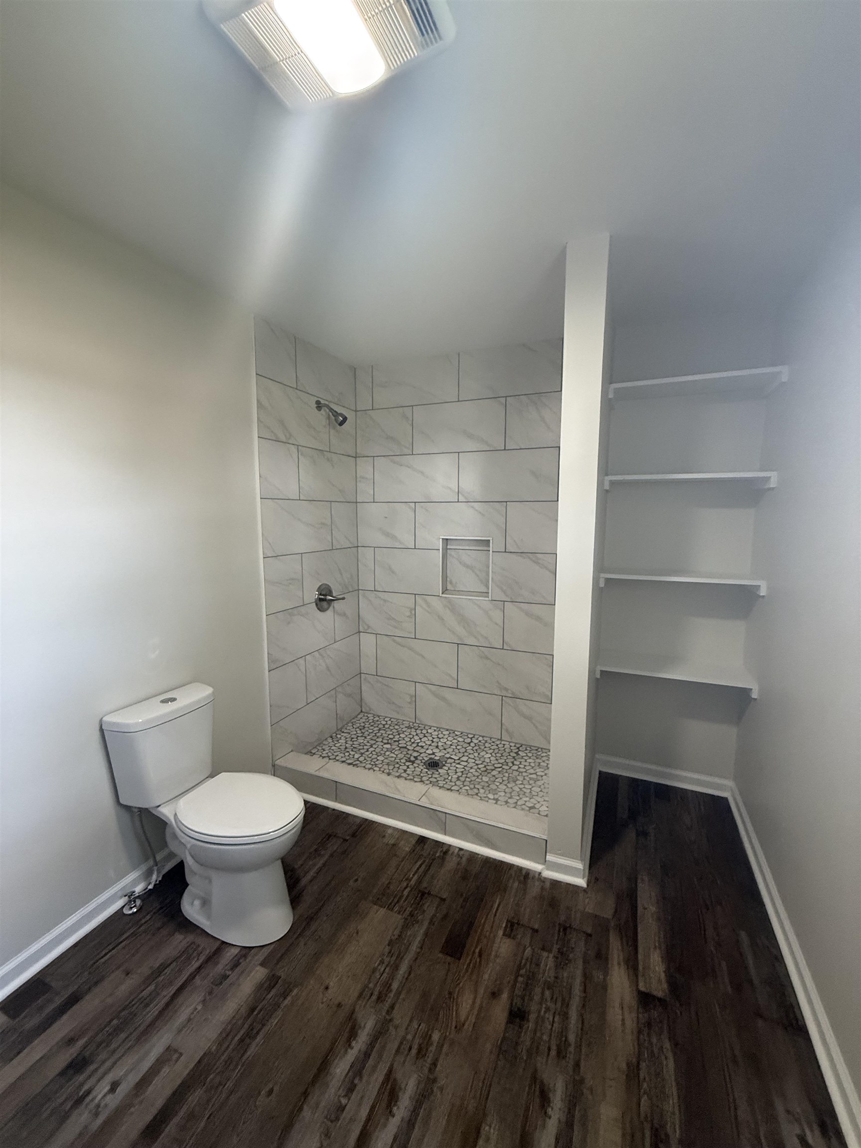 170 Leapwood Road Enville, TN 38332 - Photo 19 of 33 Walk-in shower with large format tile surround and pebble floor
