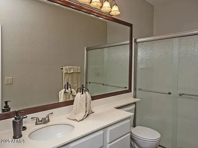 a bathroom with a sink toilet and shower