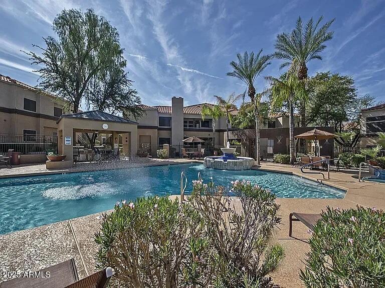 11375 East Sahuaro Drive, Unit 2041 Scottsdale, AZ 85259 - Photo 16 of 17 a front view of a house with fountain and lake view