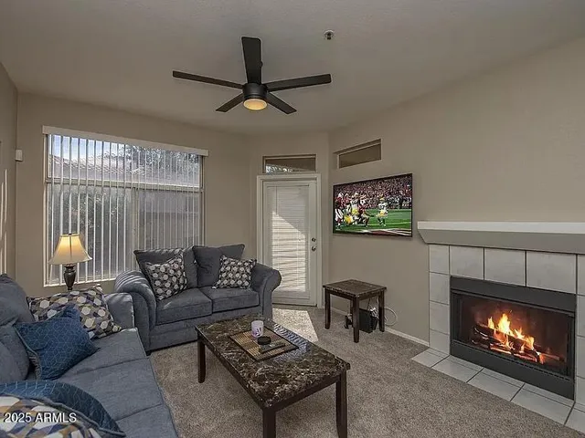 a living room with furniture a lamp and a fireplace