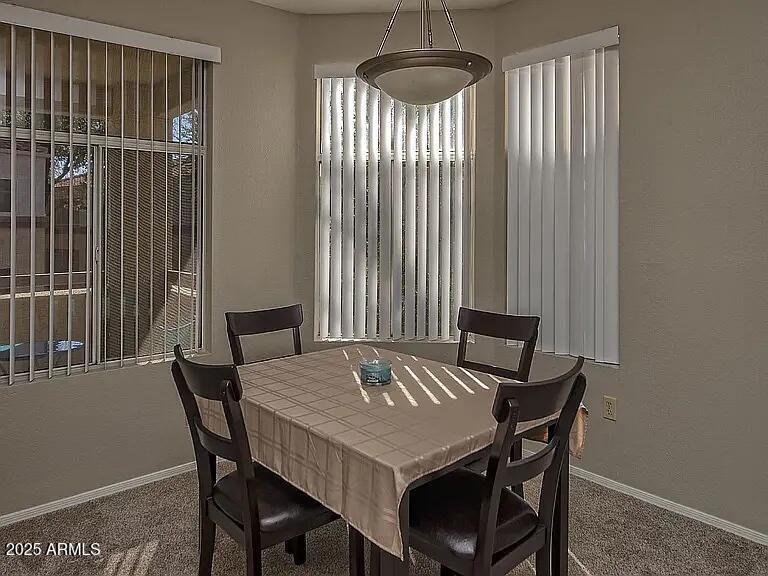 11375 East Sahuaro Drive, Unit 2041 Scottsdale, AZ 85259 - Photo 6 of 17 a view of a dining room with furniture window and wooden floor