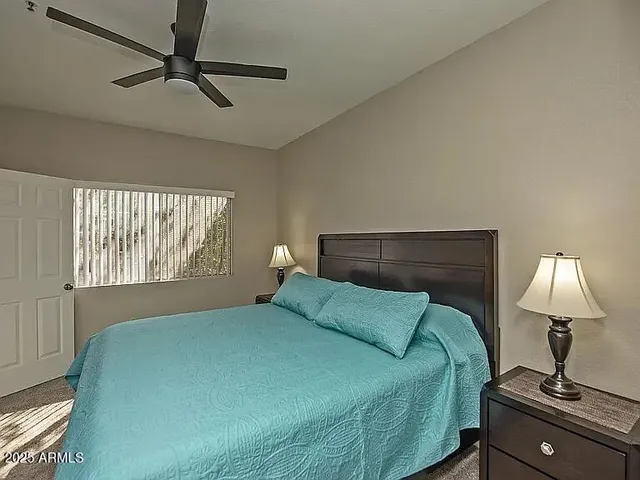 a bedroom with a bed and a window