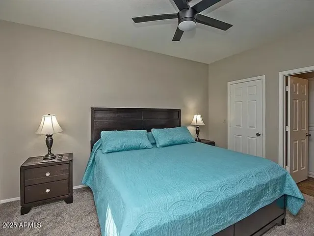a bedroom with a bed and a lamp