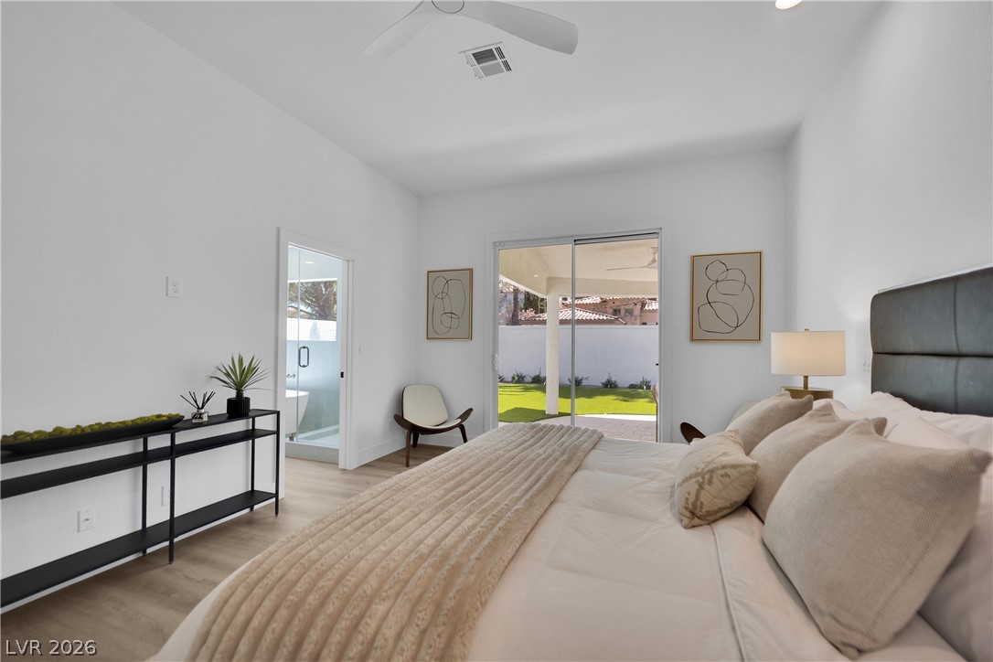 8981 Rivers Edge Drive Las Vegas, NV 89117 - Photo 34 of 69 Retreat to this serene primary bedroom offering seamless indoor-outdoor living with direct access to a private yard.