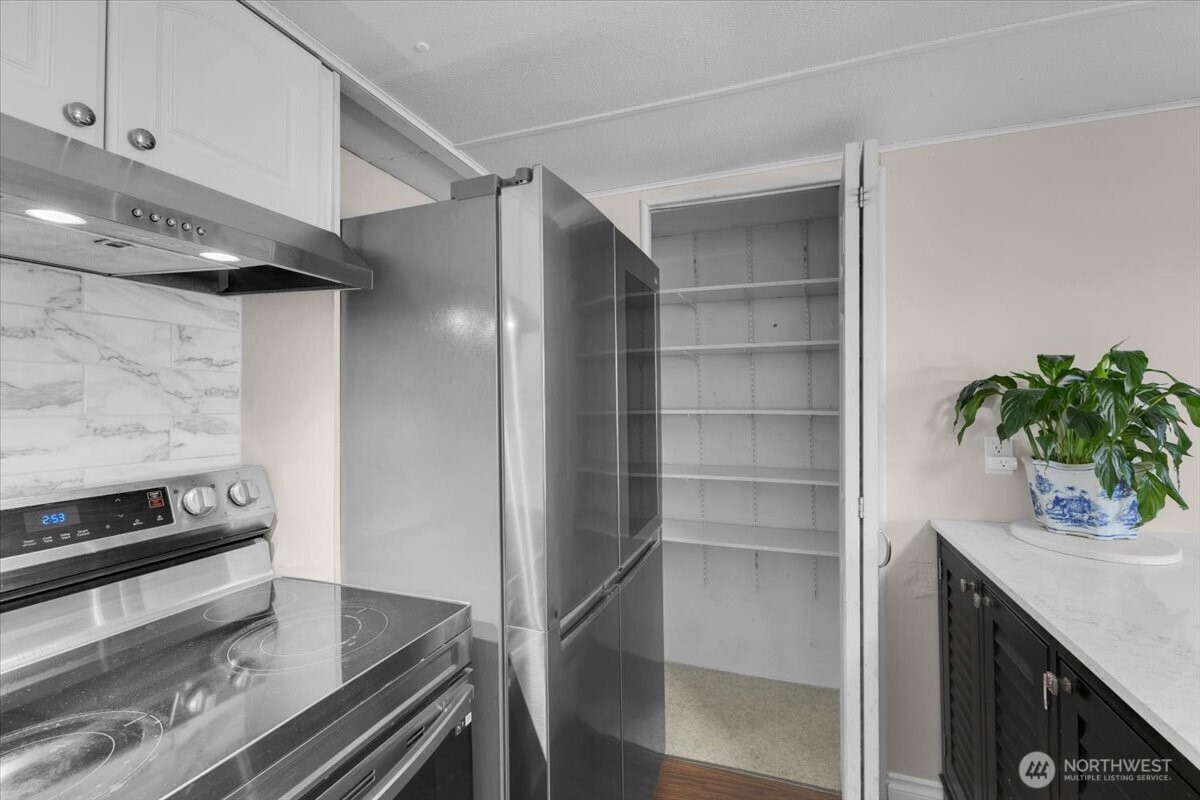 7614 Northeast Bothell Way, Unit 11 Kenmore, WA 98028 - Photo 14 of 26 a kitchen with a refrigerator and a sink