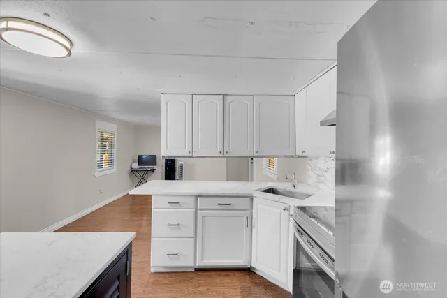 a kitchen with white cabinets and white appliances