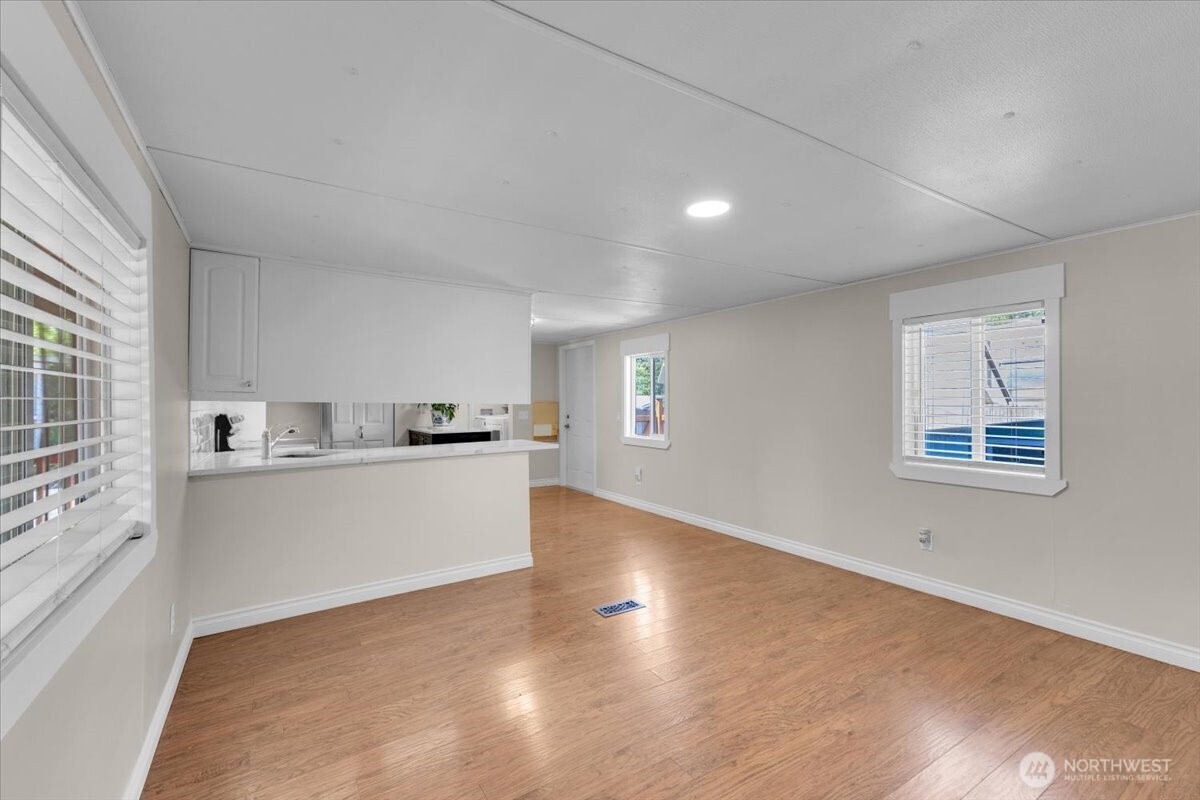 7614 Northeast Bothell Way, Unit 11 Kenmore, WA 98028 - Photo 5 of 26 a view of a kitchen with wooden floor and a sink