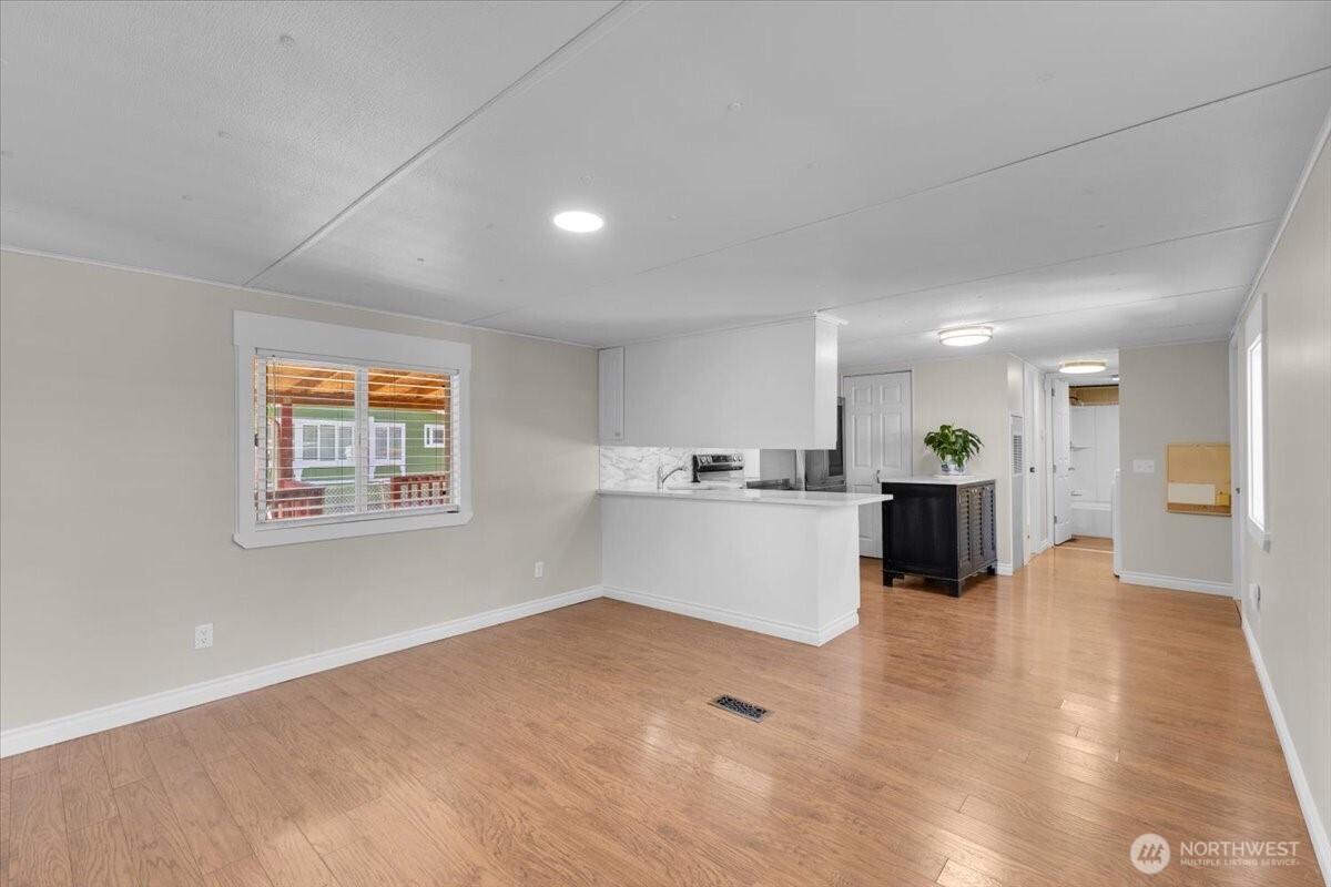 7614 Northeast Bothell Way, Unit 11 Kenmore, WA 98028 - Photo 7 of 26 a view of kitchen with wooden floor