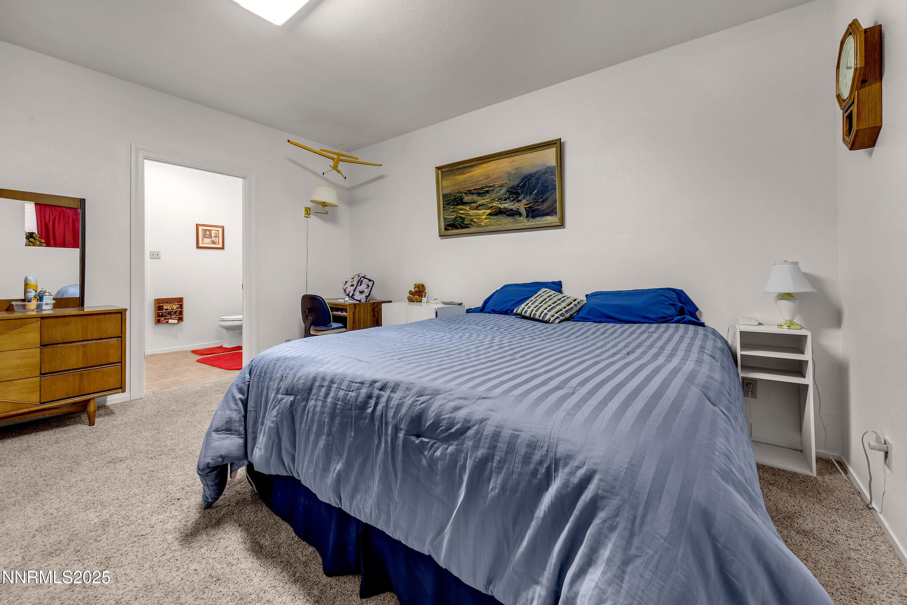 2855 Wilcox Ranch Road Reno, NV 89510 - Photo 16 of 36 a bedroom with a bed and painting on the wall