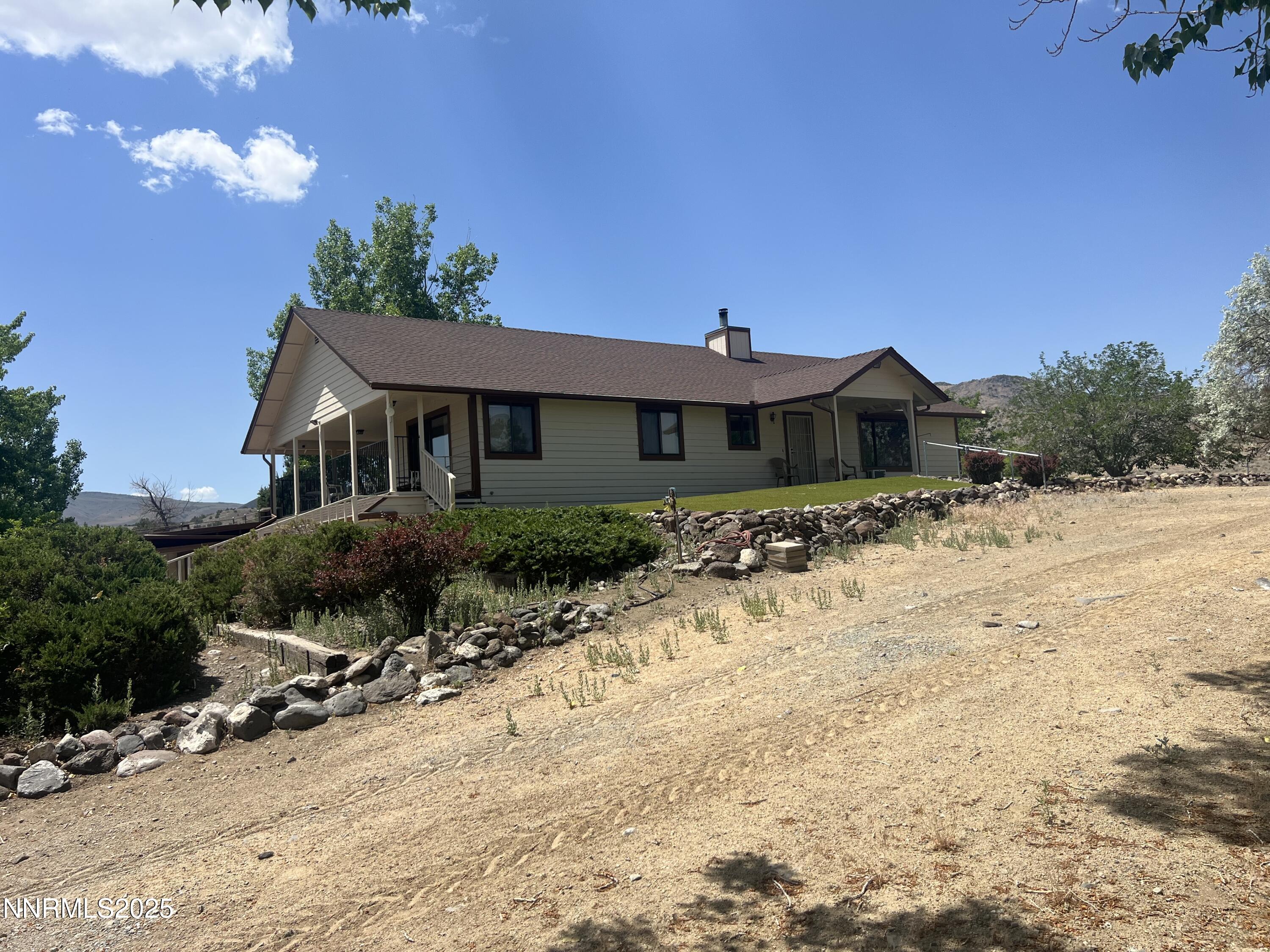 2855 Wilcox Ranch Road Reno, NV 89510 - Photo 2 of 36 a front view of a house with a yard covered with snow