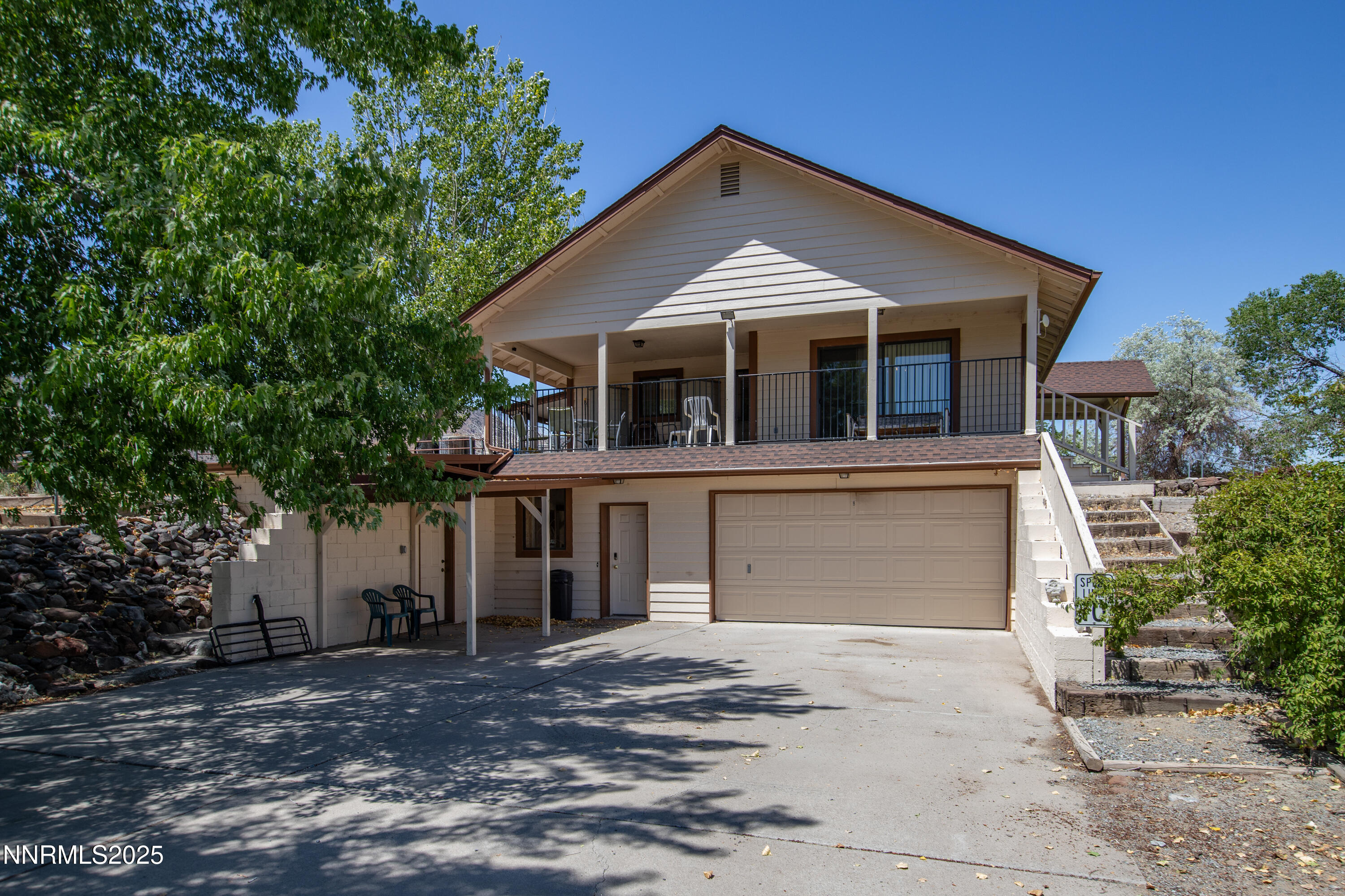 2855 Wilcox Ranch Road Reno, NV 89510 - Photo 4 of 36 a front view of a house with a yard and garage