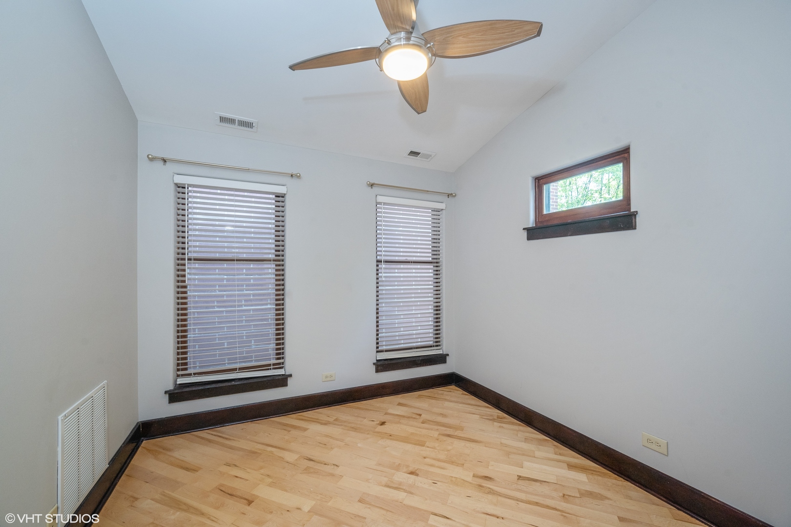 1306 West Fillmore Street, Unit 2 Chicago, IL 60607 - Photo 11 of 18 wooden floor in an empty room with a window