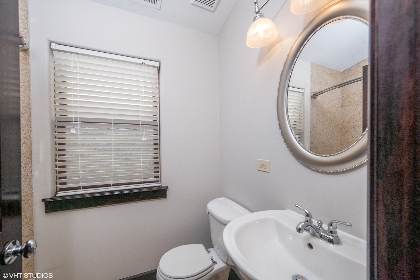 1306 West Fillmore Street, Unit 2 Chicago, IL 60607 - Photo 12 of 18 a bathroom with a sink a toilet and a mirror