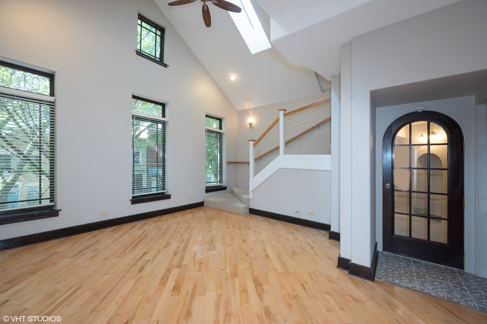 1306 West Fillmore Street, Unit 2 Chicago, IL 60607 - Photo 2 of 18 an empty room with wooden floor and windows