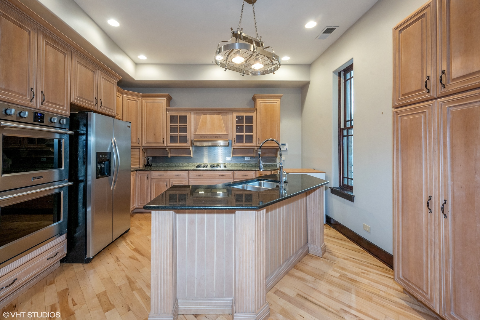 1306 West Fillmore Street, Unit 2 Chicago, IL 60607 - Photo 4 of 18 a kitchen with stainless steel appliances granite countertop a stove a refrigerator and a sink