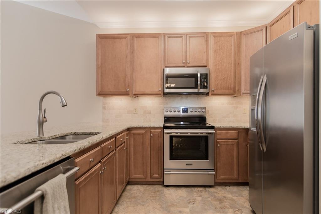 6136 Stadium Ridge Court Clemmons, NC 27012 - Photo 10 of 26 Kitchen with Granite Counter Tops, New Appliances, Large Cabinets