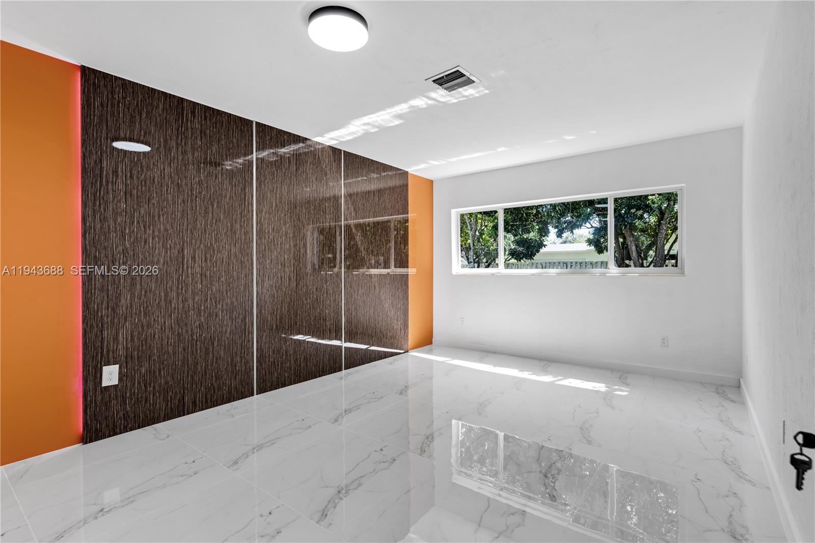 12525 Southwest 68th Court Pinecrest, FL 33156 - Photo 17 of 46 a view of an empty room with windows