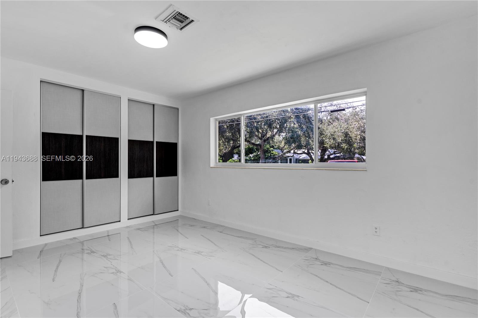 12525 Southwest 68th Court Pinecrest, FL 33156 - Photo 25 of 46 a view of empty room with windows
