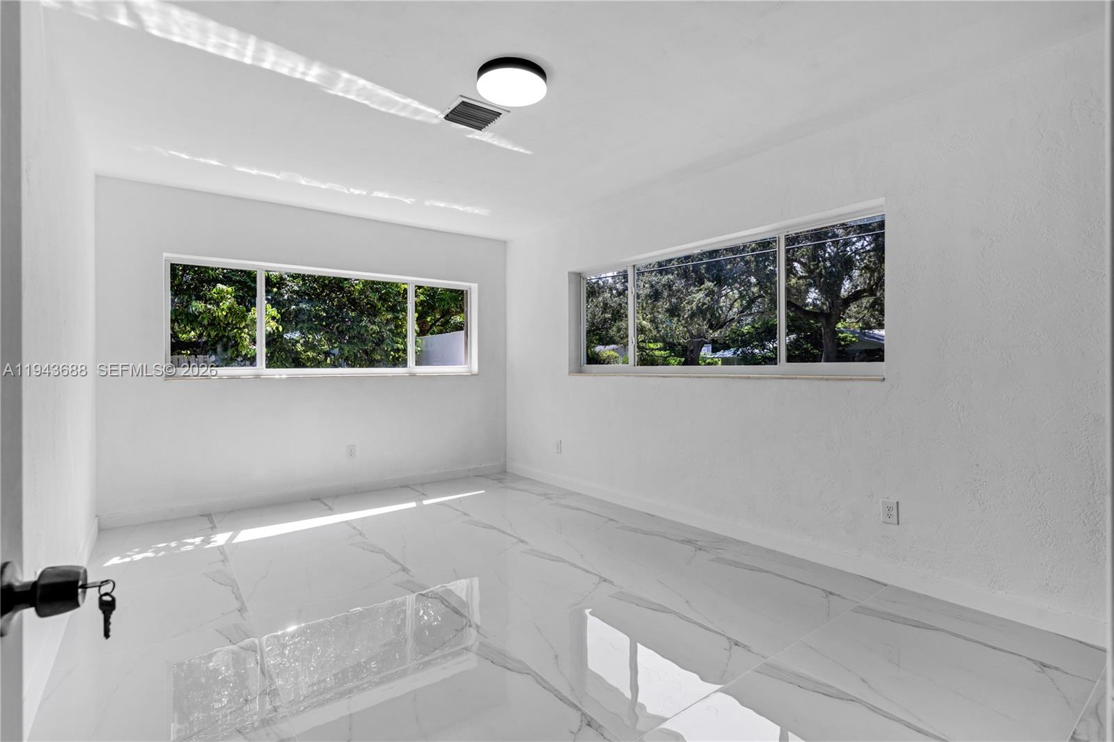 12525 Southwest 68th Court Pinecrest, FL 33156 - Photo 26 of 46 an empty room with a window