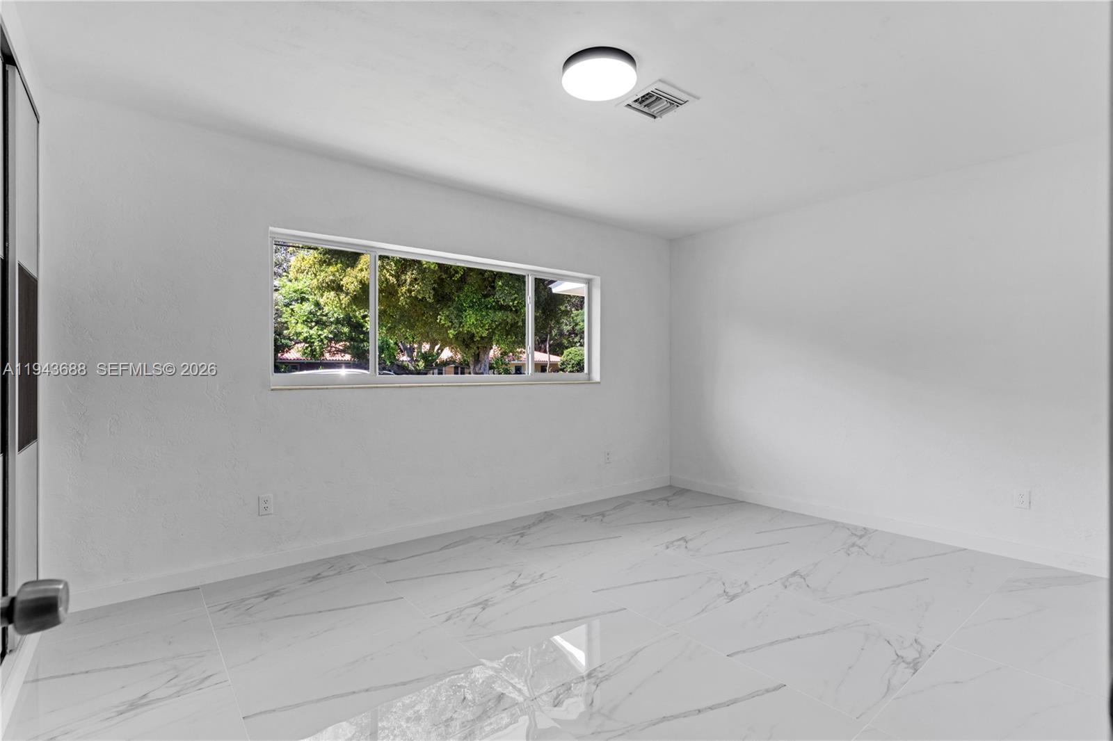 12525 Southwest 68th Court Pinecrest, FL 33156 - Photo 28 of 46 an empty room with a window