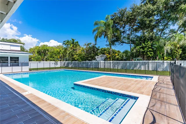 a view of swimming pool with a yard