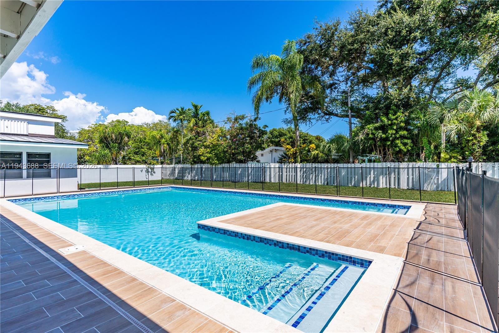 12525 Southwest 68th Court Pinecrest, FL 33156 - Photo 34 of 46 a view of swimming pool with a yard