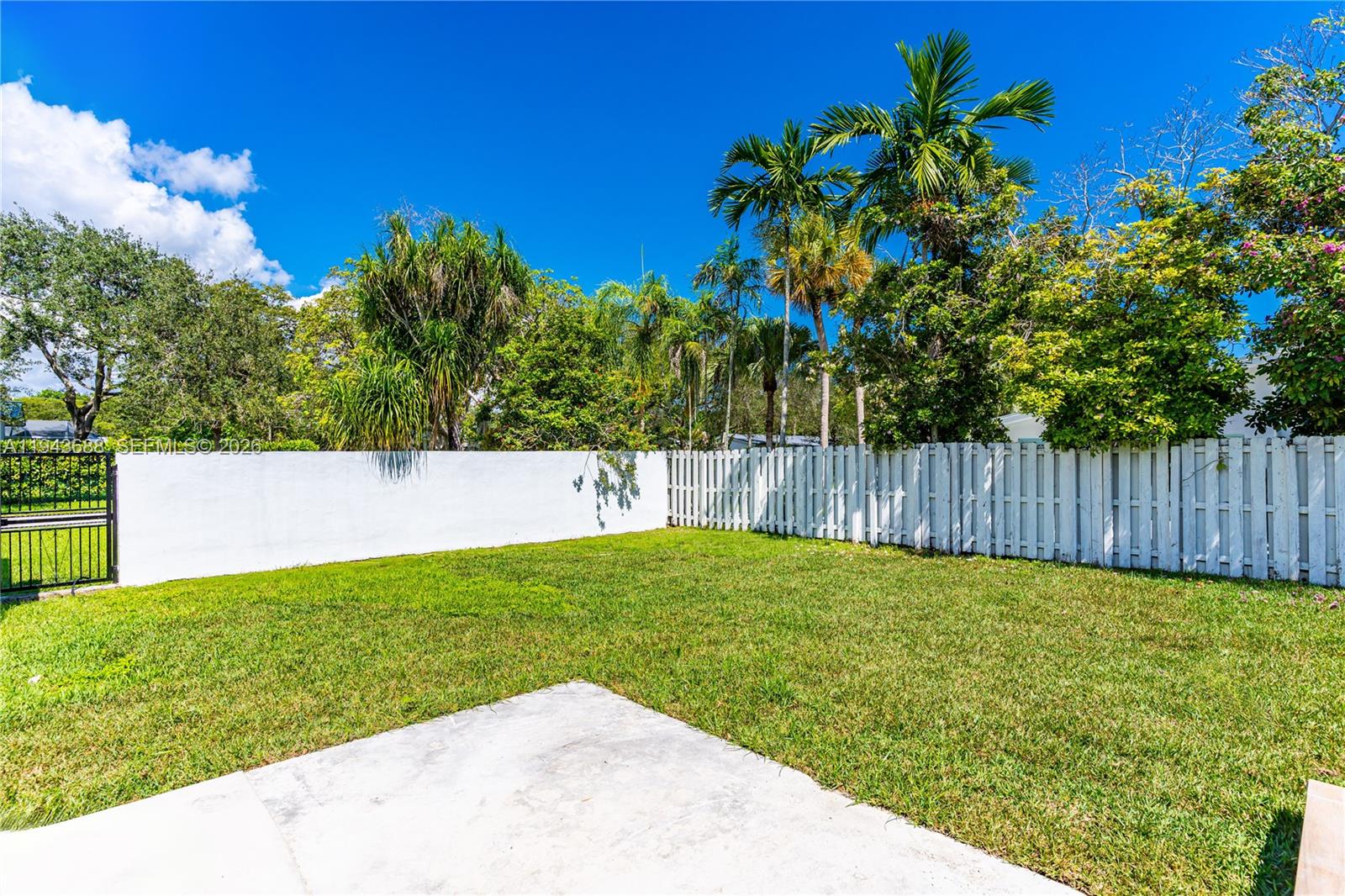 12525 Southwest 68th Court Pinecrest, FL 33156 - Photo 38 of 46 a view of yard with swimming pool and trees in the background