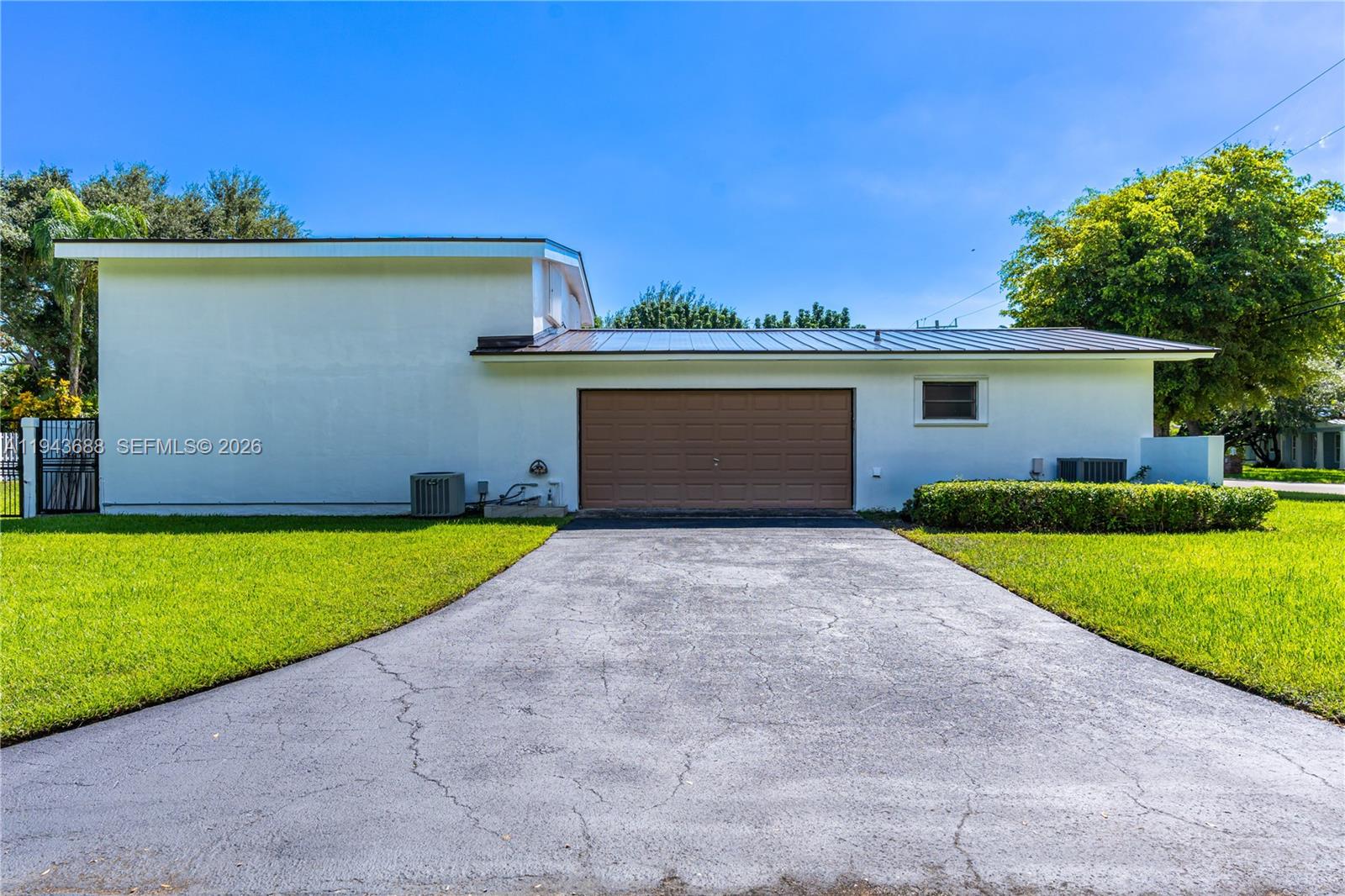 12525 Southwest 68th Court Pinecrest, FL 33156 - Photo 41 of 46 a front view of house with yard and garage
